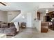 Inviting living room featuring a comfortable brown sofa and staircase leading to the upper level at 14404 N Boxwood Ln, Fountain Hills, AZ 85268