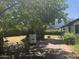 Inviting outdoor patio area with brick pavers, BBQ, shade trees and lush greenery at 1447 E Town And Country Ln, Phoenix, AZ 85014