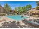 Community pool with spa, lounge chairs and shaded cabana with picnic table at 15050 N Thompson Peak Pkwy # 1001, Scottsdale, AZ 85260
