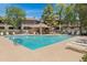 Community pool with lounge seating and shaded picnic area with tables and chairs at 15050 N Thompson Peak Pkwy # 1001, Scottsdale, AZ 85260