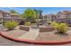 Circular courtyard with water feature and colorful manicured landscaping at 15050 N Thompson Peak Pkwy # 1001, Scottsdale, AZ 85260