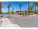 Community entrance with palm trees, manicured landscaping and block signage at 15050 N Thompson Peak Pkwy # 1001, Scottsdale, AZ 85260