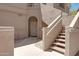 Close-up of the front entrance with an arched doorway and staircase leading to upper levels at 15050 N Thompson Peak Pkwy # 1001, Scottsdale, AZ 85260