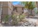 Multi-level condo building with beige stucco exterior, landscaping, and stairways to upper units at 15050 N Thompson Peak Pkwy # 1001, Scottsdale, AZ 85260