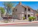 A pleasing two-story building with red trim, shaded balconies and well-kept landscaping at 15050 N Thompson Peak Pkwy # 1001, Scottsdale, AZ 85260