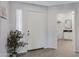 Inviting foyer with white door, neutral tile flooring, and access to a bathroom at 15050 N Thompson Peak Pkwy # 1001, Scottsdale, AZ 85260