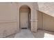 Entrance with a white front door, decorative archway, and address number at 15050 N Thompson Peak Pkwy # 1001, Scottsdale, AZ 85260