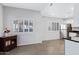 Bright, open room featuring white walls, shuttered windows, and an adjacent kitchen area at 15050 N Thompson Peak Pkwy # 1001, Scottsdale, AZ 85260