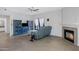 Spacious living room with a sofa, fireplace, and blue shelving units for display at 15050 N Thompson Peak Pkwy # 1001, Scottsdale, AZ 85260