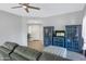 Comfortable living room with stylish blue shelving units, ceramic flooring, and a sofa at 15050 N Thompson Peak Pkwy # 1001, Scottsdale, AZ 85260