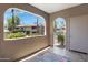 Private covered patio offers tiled floor and views of the lush green landscaping at 15050 N Thompson Peak Pkwy # 1001, Scottsdale, AZ 85260