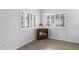Bright room with white walls, two shuttered windows, and a wooden cabinet at 15050 N Thompson Peak Pkwy # 1001, Scottsdale, AZ 85260