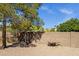 Desert backyard with brick block fence and a wheelbarrow at 16002 E Gleneagle Dr, Fountain Hills, AZ 85268