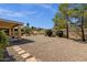 Spacious backyard featuring a covered patio area, desert landscaping, and block fencing at 16002 E Gleneagle Dr, Fountain Hills, AZ 85268