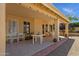 Spacious covered patio featuring tiled flooring, multiple seating areas, and views of backyard at 16002 E Gleneagle Dr, Fountain Hills, AZ 85268