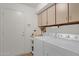 Laundry room equipped with washer, dryer, and storage cabinets at 16002 E Gleneagle Dr, Fountain Hills, AZ 85268