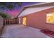 Rear view of a home showcasing a brick wall, sliding glass door, and concrete patio, creating a private outdoor space at 17220 N 55Th Ave, Glendale, AZ 85308