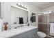Bathroom featuring a marble vanity, updated fixtures, and enclosed shower at 17220 N 55Th Ave, Glendale, AZ 85308