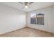 Bedroom with a ceiling fan and a sunlit window at 17220 N 55Th Ave, Glendale, AZ 85308