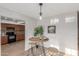 Eat-in kitchen dining area features a bistro table, seating, and an updated modern light fixture at 17220 N 55Th Ave, Glendale, AZ 85308