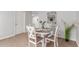 Bright dining area with a round wood table, decorative chairs, and neutral paint palette at 17220 N 55Th Ave, Glendale, AZ 85308