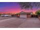 View of a charming single-story home with a two-car garage and low maintenance gravel landscaping at 17220 N 55Th Ave, Glendale, AZ 85308