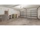 Spacious garage with an automatic door, concrete floor, and ample storage for vehicles and equipment at 17220 N 55Th Ave, Glendale, AZ 85308