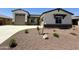 Charming single-story home features a neutral exterior with stone accents, a two-car garage, and low-maintenance landscaping at 17324 W Royal Palm Rd, Waddell, AZ 85355