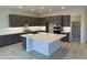 Open concept kitchen featuring dark cabinets, large island, and recessed lighting at 17324 W Royal Palm Rd, Waddell, AZ 85355