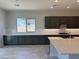 Open concept kitchen featuring dark cabinets, large island, recessed lighting, and subway tile backsplash at 17324 W Royal Palm Rd, Waddell, AZ 85355