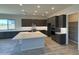 Open concept kitchen featuring dark cabinets, large island, and walk-in pantry at 17324 W Royal Palm Rd, Waddell, AZ 85355