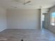 Open-concept living room with light wood-look tile flooring and neutral colored walls at 17324 W Royal Palm Rd, Waddell, AZ 85355