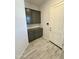 Mud room with gray cabinets, a countertop, an electrical outlet, an electronic keypad and a white door at 17324 W Royal Palm Rd, Waddell, AZ 85355