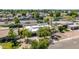A modern home with a pristine white roof, desert landscaping, and a two car garage at 1736 N Ashbrook Cir, Mesa, AZ 85213