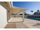 An inviting covered back patio overlooks the sparkling pool and well-maintained backyard at 1736 N Ashbrook Cir, Mesa, AZ 85213