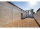 Low maintenance backyard with gravel, fence, and AC unit at 1736 N Ashbrook Cir, Mesa, AZ 85213