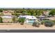 This beautiful backyard has a private pool, solar panels, and an enclosed block fence at 1736 N Ashbrook Cir, Mesa, AZ 85213