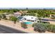 Aerial view of a home with a backyard pool, covered patio and solar panels at 1736 N Ashbrook Cir, Mesa, AZ 85213