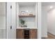 Elegant bar area featuring a wine cooler, wooden cabinets, and stylish decor at 1736 N Ashbrook Cir, Mesa, AZ 85213