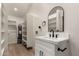 Bright bathroom features a vanity, modern fixtures, ample storage shelving, and a walk-in closet at 1736 N Ashbrook Cir, Mesa, AZ 85213
