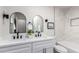 This bathroom features a dual sink vanity, modern faucets, and stylish mirrors at 1736 N Ashbrook Cir, Mesa, AZ 85213