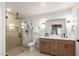 Modern bathroom featuring a glass-enclosed shower and double sink vanity with sleek fixtures at 1736 N Ashbrook Cir, Mesa, AZ 85213