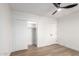 Cozy bedroom featuring light-colored floors, a closet, and a ceiling fan at 1736 N Ashbrook Cir, Mesa, AZ 85213