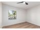 Bright bedroom featuring a ceiling fan and large window providing natural light at 1736 N Ashbrook Cir, Mesa, AZ 85213