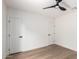 Bedroom features wood floors, contemporary ceiling fan, fresh paint and new door hardware for a contemporary look at 1736 N Ashbrook Cir, Mesa, AZ 85213