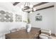 Elegant dining room with modern chandelier, wood table, stylish chairs, and decorative wall art at 1736 N Ashbrook Cir, Mesa, AZ 85213