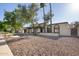 Charming home exterior with desert landscaping, unique architectural features, and a bright, welcoming ambiance under a sunny sky at 1736 N Ashbrook Cir, Mesa, AZ 85213