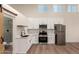 Bright kitchen features white cabinetry, stainless appliances, an open layout, and walk-in shower at 1736 N Ashbrook Cir, Mesa, AZ 85213