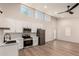 Bright kitchen features white cabinetry, stainless appliances, and an open layout with ample natural light at 1736 N Ashbrook Cir, Mesa, AZ 85213