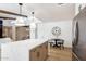 Bright open kitchen features a large island, stainless appliances, and modern lighting fixtures at 1736 N Ashbrook Cir, Mesa, AZ 85213